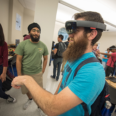 Student test drives new app on HTC Vive system widely used by VR Club members.