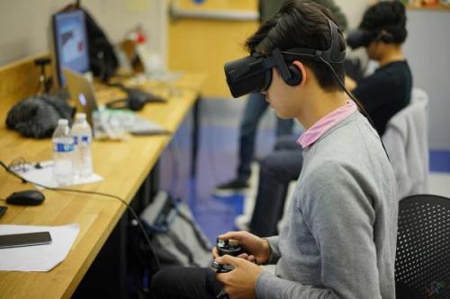 A HackXR student participant working on his team&#039;s PlatformXR virtual reality project. PlatformXR encourages users new to the VR environment to explore what&#039;s possible in the virtual world. Photo credit Robin Xu/ UC San Diego VR Club