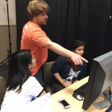 Members of HackXX winning team get pointers from VR Club president and mentor.