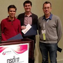 CSE Prof. George Porter (center) and co-authors Rodrigo Fonseca (left) and Ion Stoica accept their Test of Time Award at NSDI 2017 in Boston.