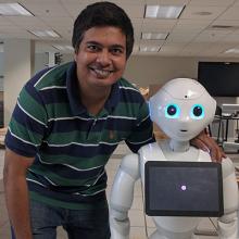 Ph.D. candidate Tariq Iqbal with robot used in his research.